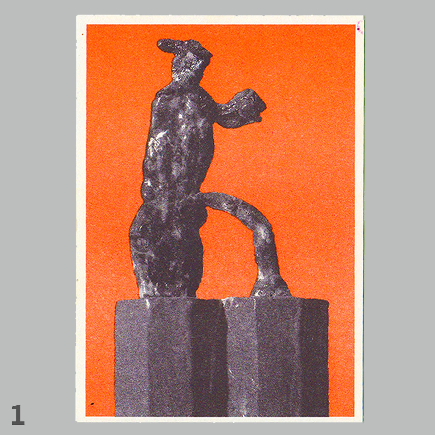 Black statue on a pedestal against an orange background